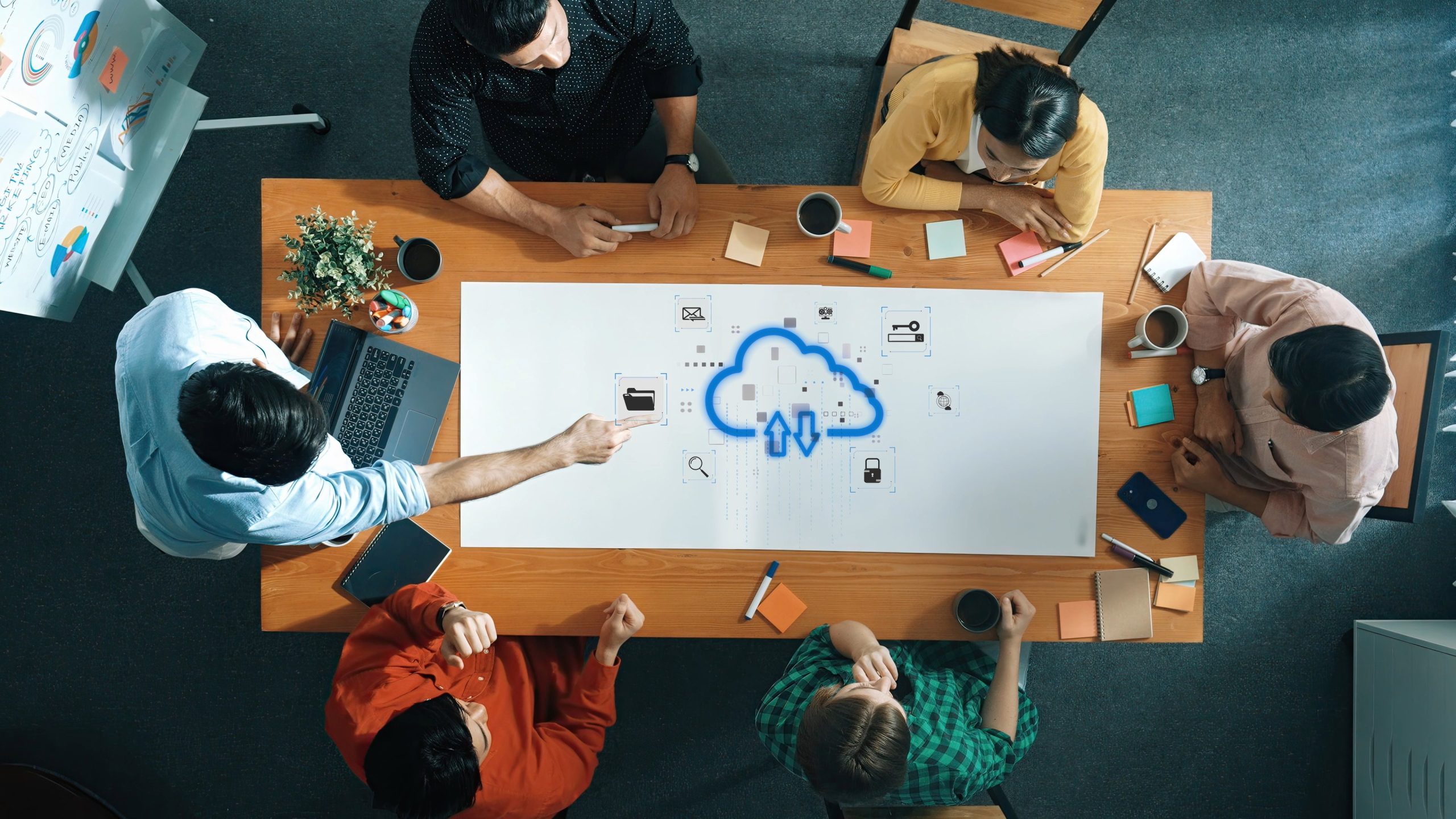 team collaboration in office with cloud computing concept, diverse group brainstorming ideas on table surrounded by technology and notes. raster